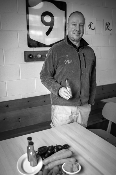 Gordon Sacks holds a bottle of one of the new line of hot sauces made from ingredients grown at 9 Miles East Farm. Joan K. Lentini photo Gordon Sacks holds a bottle of one of the new line of hot sauces made from ingredients grown at 9 Miles East Farm. Joan K. Lentini photo