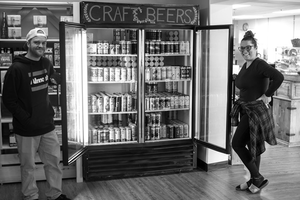 Retail manager Riley Flynn, left, and general manager Diana Shepherd show off the selection of craft beer at the new Bennington Community Market. Joan K. Lentini photo