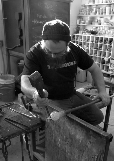 Michael Scupholm, the glass studio director at Salem Art Works in Salem, N.Y., shapes a blown-glass ornament. The pandemic has forced artists to work alone in SAW’s studios, rather than in groups. Courtesy photo