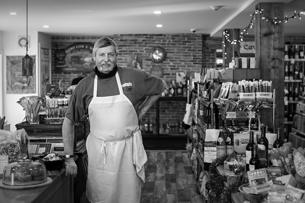 Gib Mach, the owner of Mach’s Market, stands inside the revamped store, which reopened last spring after being shuttered for five years. Joan K. Lentini photo