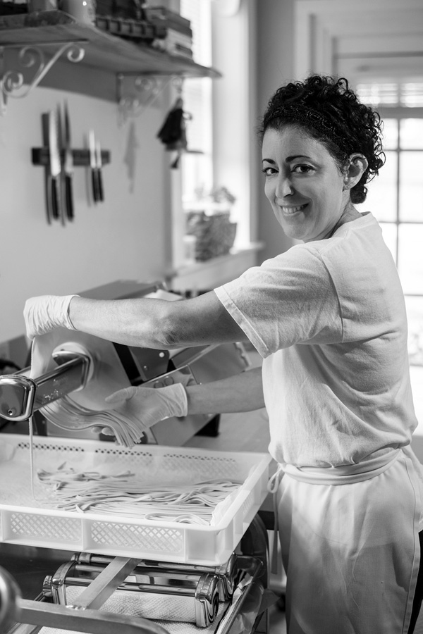 Rose Contadino feeds her rolled dough through a pasta cutter to turn it into fettuccine noodles at her shop in Saratoga Springs. Joan K. Lentini photo Rose Contadino feeds her rolled dough through a pasta cutter to turn it into fettuccine noodles at her shop in Saratoga Springs. Joan K. Lentini photo